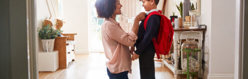Mother gets her child ready for school.