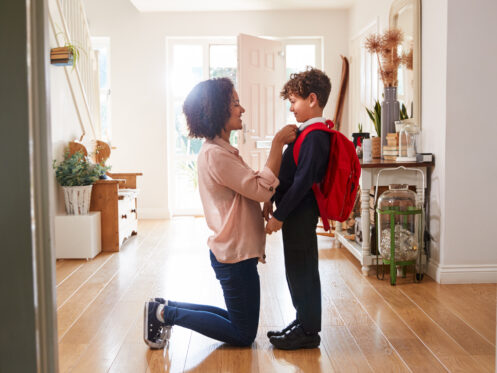 Mother gets her child ready for school.