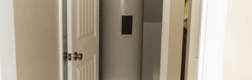A water heater in a storage closet.
